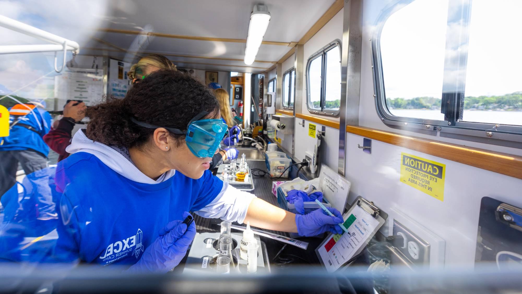 Students conduct lab analyses during a cruise on the W.G. Jackson